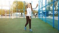 One active young girl, fit sporty child climbing, outdoor exercise, hanging on a bar on a playground, portrait, closeup. Children