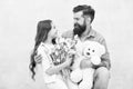 One adoption is enough to change lives. Adoptive family. Bearded man and little girl hold flowers and toy. Child