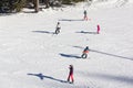 One adult and four children enjoying good snow