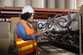 A female industrial worker checks the machine in a paper manufacturing factory Royalty Free Stock Photo