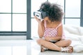 One African mixed race girl enjoy with VR glasses and also hold laptop in the room with day light