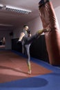 one agressive boxer exercising,high leg kick,