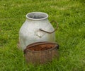 One aluminium and one rusty pots grass background, on Isle of Iona,near Mull, Argyll and Bute,Scotland,UK.