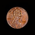 One american cent coin on black background