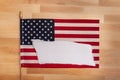 One American flag stars and stripes with one white torn edges sheet of paper blank