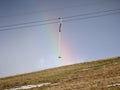 One anchor on the ski lift with a rainbow on the background