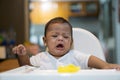 One asian baby crying on Dining chair Royalty Free Stock Photo