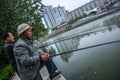 One Asian Chinese man fishing in pond