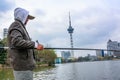 One Asian Chinese man fishing in pond