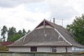 One attic on a gray slate roof of a rural house Royalty Free Stock Photo