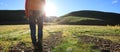 Backpacking woman hiking in sunrise mountains