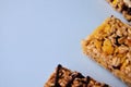 One bar of muesli close-up on a blue background with a copy space