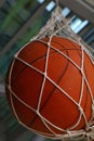 One basketball ball hanging in mesh sack Royalty Free Stock Photo