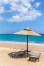 One beach umbrella and sunloungers near ocean Royalty Free Stock Photo