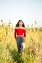 One beautiful female caucasian high school senior girl in red crop top sweater