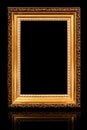 One beautiful old antique empty wooden gold frame on black background. Royalty Free Stock Photo