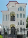 One beautiful three-story house with a metal fencein the summer.