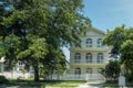 One beautiful three-story house with trees, and landscape design in the summer