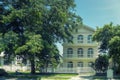 One beautiful three-story house with trees, and landscape design in the summer.