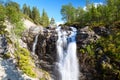 One of beautiful waterfalls in the Khibiny mountains. Sunny day with blue sky. The Kola peninsula, Russia