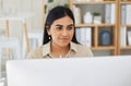 One beautiful young mixed race business woman working on her computer in the office at work. Confident and successful Royalty Free Stock Photo