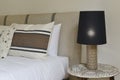 One bedroom headboard upholstered in beige fabric, matching cushions