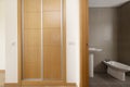 One bedroom suite bathroom with built-in wardrobe with sliding oak doors with aluminum edges Royalty Free Stock Photo