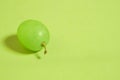 One berry of green grapes in close-up on a colored background Royalty Free Stock Photo
