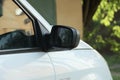 One big black  plastic car mirror next to the gray glass Royalty Free Stock Photo