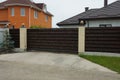 One big closed brown private gate and part of the fence Royalty Free Stock Photo