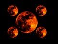 One big and four small bright full orange red blood moon on black background wallpaper with repeated figures. Royalty Free Stock Photo