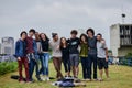 One big happy campus family. Portrait of a group of young students standing arms around each other outside in a park Royalty Free Stock Photo