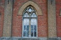 Large old window behind bars on a brick wall of a building Royalty Free Stock Photo