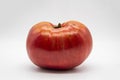 One big ripe red tomato isolated on a white background. Healthy food concept Royalty Free Stock Photo