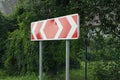 One big road sign turning direction with red  white arrows Royalty Free Stock Photo