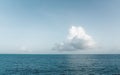 One big white cloud in blue sky over sea landscape. Cloud above ocean water panorama, horizon, beautiful tropical Royalty Free Stock Photo