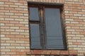 One big wooden old window on brown brick wall Royalty Free Stock Photo