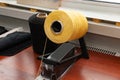 One big yellow bobbin with large mating colored threads in the studio fot interior design workshop on the table with thread Royalty Free Stock Photo
