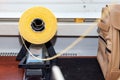 One big yellow bobbin with large mating colored threads in the studio for interior design workshop on the table with thread