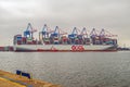 Huge 400 m long container ship mooring in cloudy day