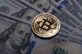 One Bitcoin on hundred dollars bills. Royalty Free Stock Photo