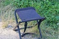 One black folding chair made of fabric and metal