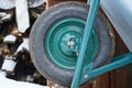 Black green wheel on a metal garden wheelbarrow Royalty Free Stock Photo