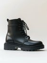 Black high combat boot on white background. Royalty Free Stock Photo