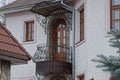 Black iron open balcony with a brown door on the wall with windows Royalty Free Stock Photo