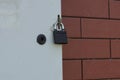 One black iron padlock hanging on a gray metal door Royalty Free Stock Photo