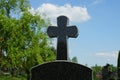 One black marble cross on the monument at the grave in the cemetery