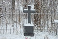 One black marble monument with a cross on a grave Royalty Free Stock Photo