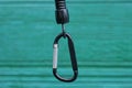 One black metal carabiner clasp on a plastic wire Royalty Free Stock Photo