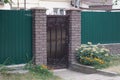 One black metal door with wrought iron pattern on the wall Royalty Free Stock Photo